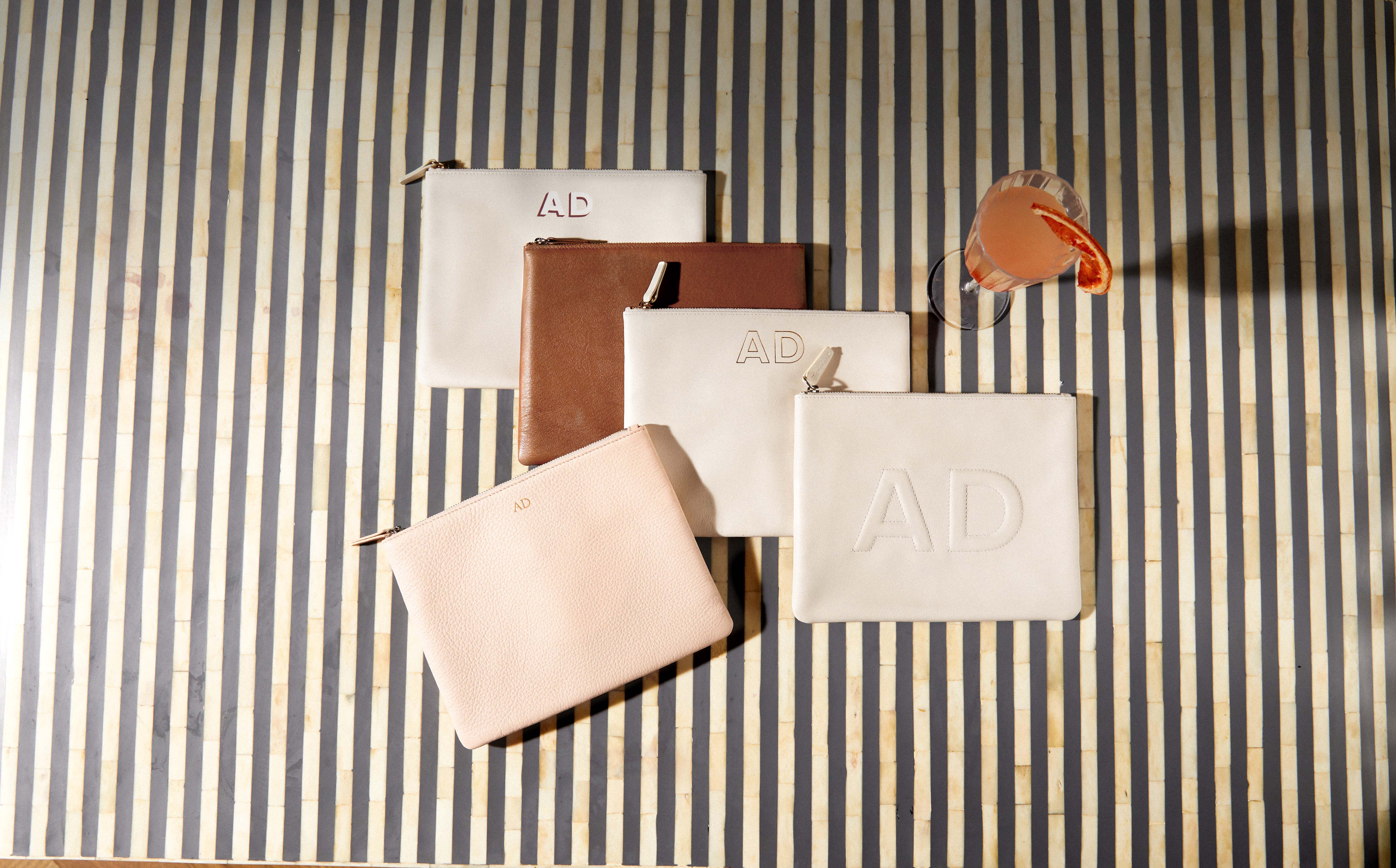 Personalized Medium Leather Pouches on Striped Background